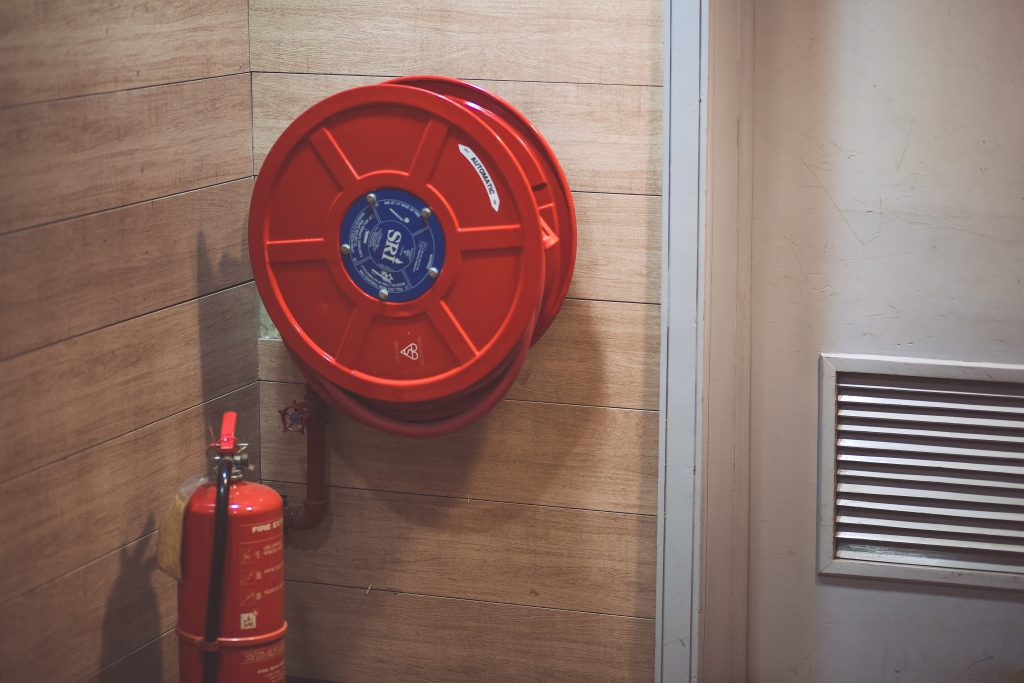 red-fire-extinguisher-below-hose-reel-189474 fire_extinguisher_1665853497-e1665853541343.jpeg Oluwaseun Duncan at Pexels