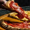 photo-of-person-holding-sliced-pizza-3915857 pizza_1675984735.jpeg Horizon Content at Pexels