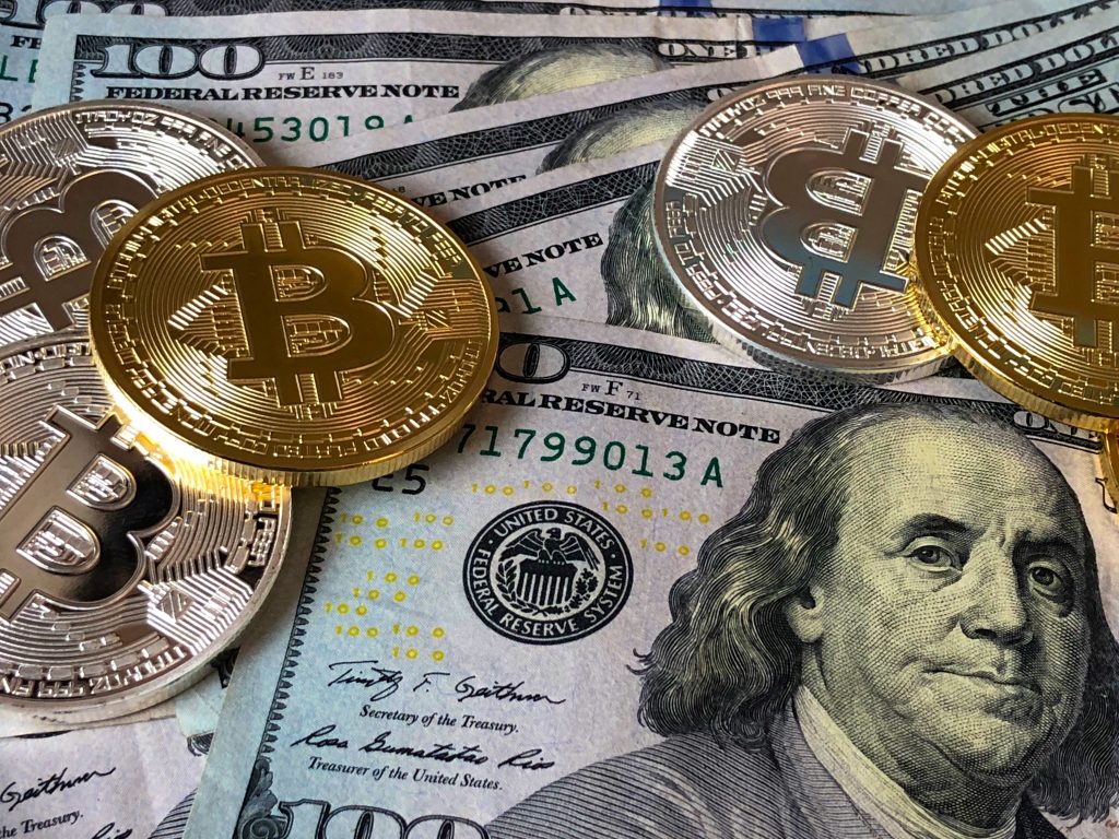 bitcoins-and-u-s-dollar-bills-730547 financial_1678513566.jpeg David McBee at Pexels