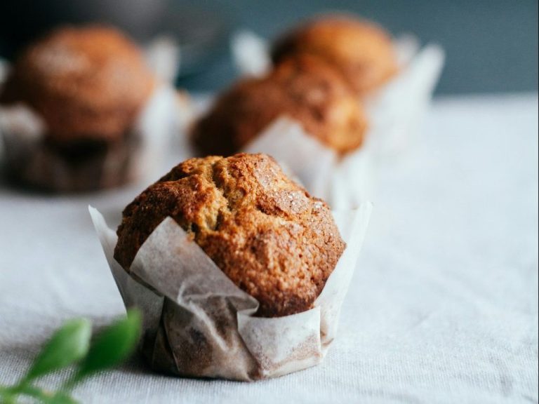 baked muffin on beige surface