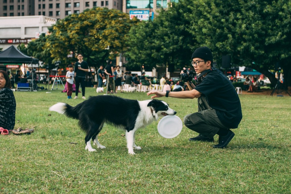 man holding black and white dog.jpg
