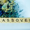 a wooden block spelling passover next to a bouquet of flowers.jpg
