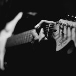 grayscale photography of person playing electric guitar.jpg