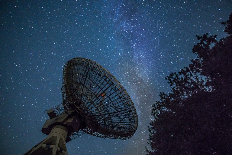 white satellite dish under blue sky during night time.jpg