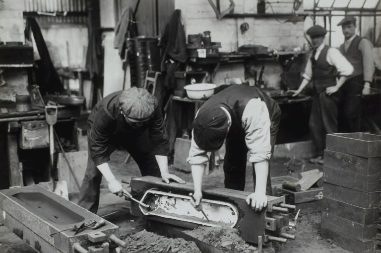 grayscale photo of two men cleaning container,jpg