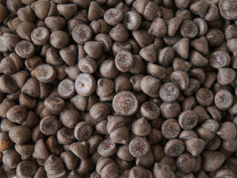 brown coffee beans on brown wooden surface.jpg