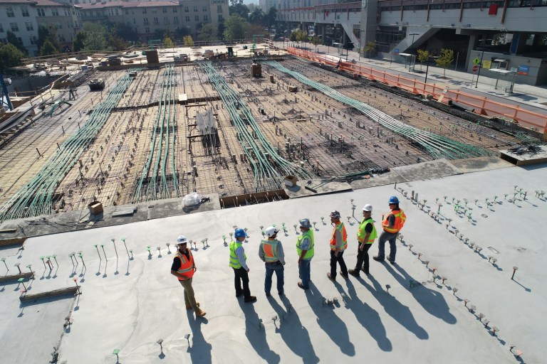 seven construction workers standing on white field.jpg