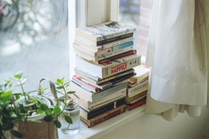 assorted-title book lot beside window.jpg