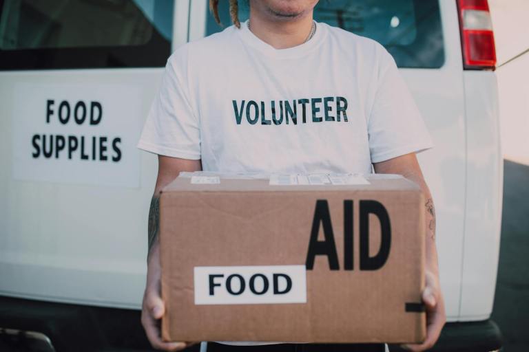 Volunteer Holding Box of Food Aid.jpg