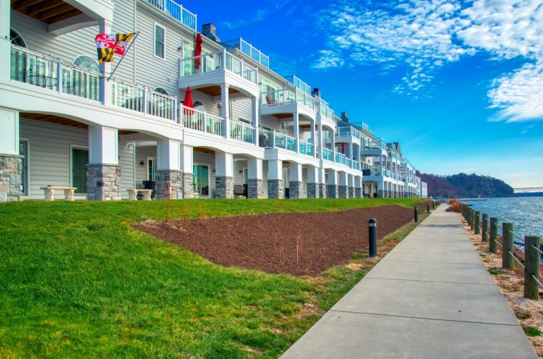 a row of apartment buildings next to a body of water.jpg