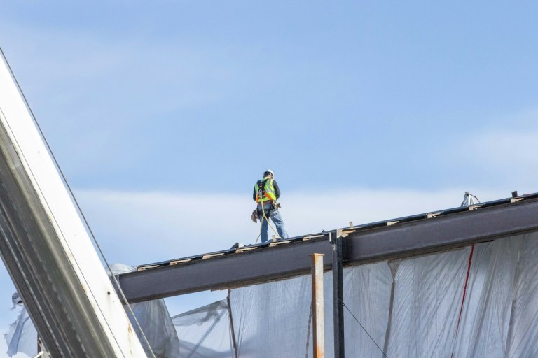 a man standing on top of a metal structure.jpg