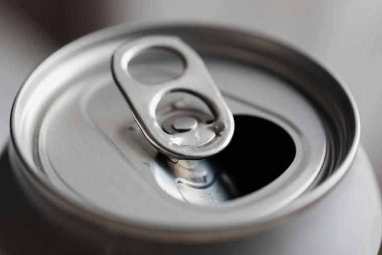 Close-up view of an open aluminum can, highlighting its metallic texture and design..jpg