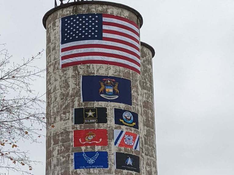 a tall tower with a lot of stickers on it