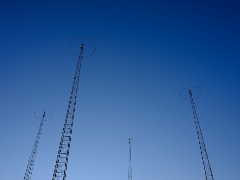 white metal electric post under blue sky during daytime.jpg