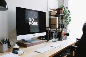 silver iMac with keyboard and trackpad inside room.jpg