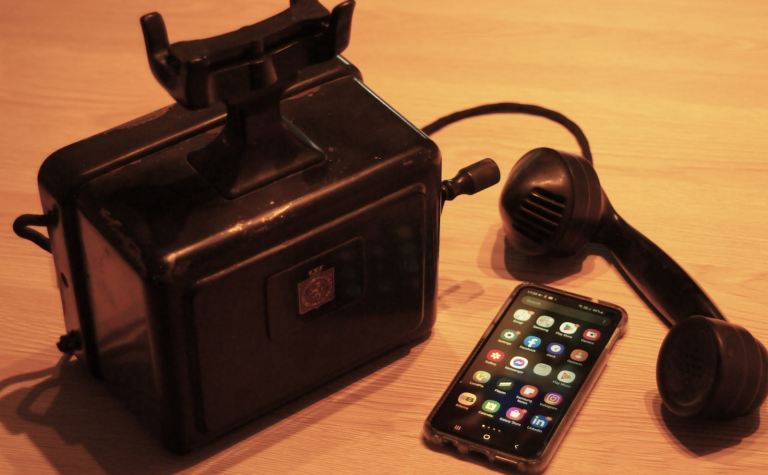 a black phone next to a black box with a cordjpg