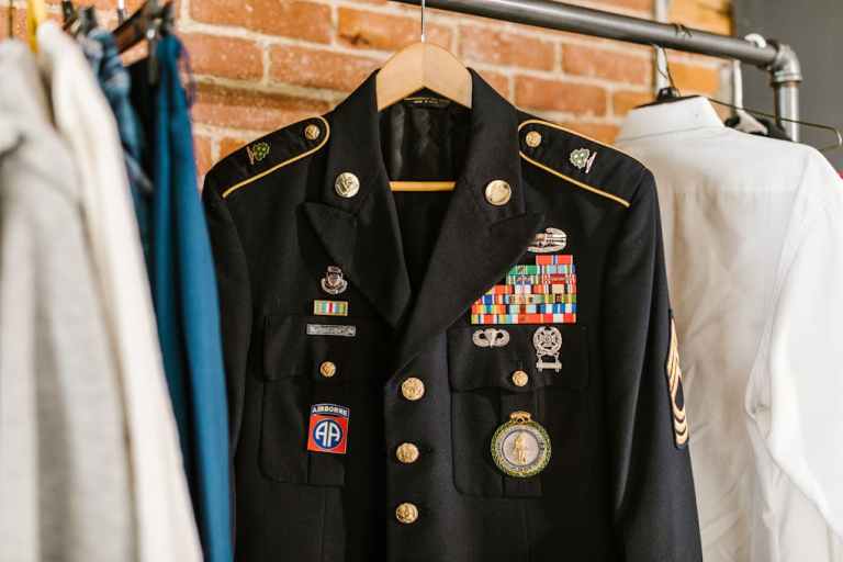 Close-up of a decorated military uniform with medals on a hanger indoors..jpg