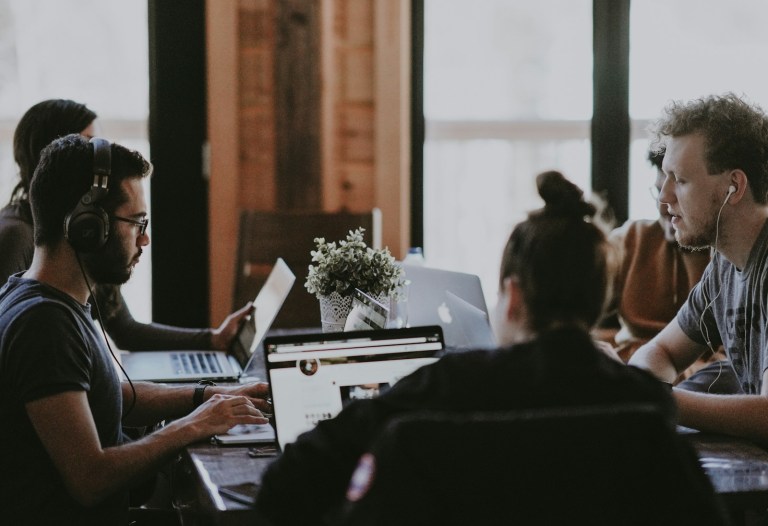 selective focus photography of people sits in front of table inside room.jpg