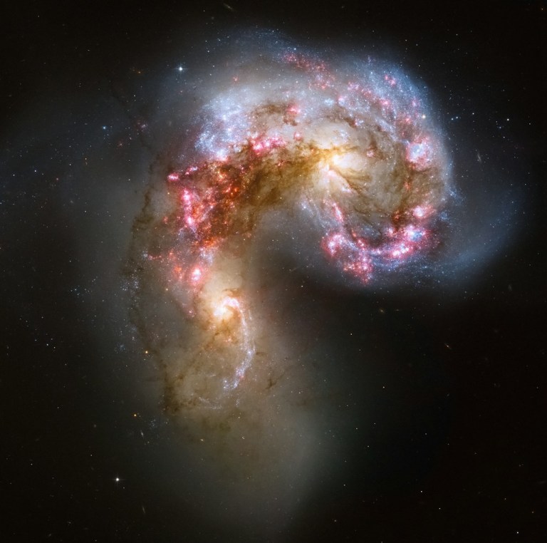 two spiral shaped objects in the dark sky.jpg
