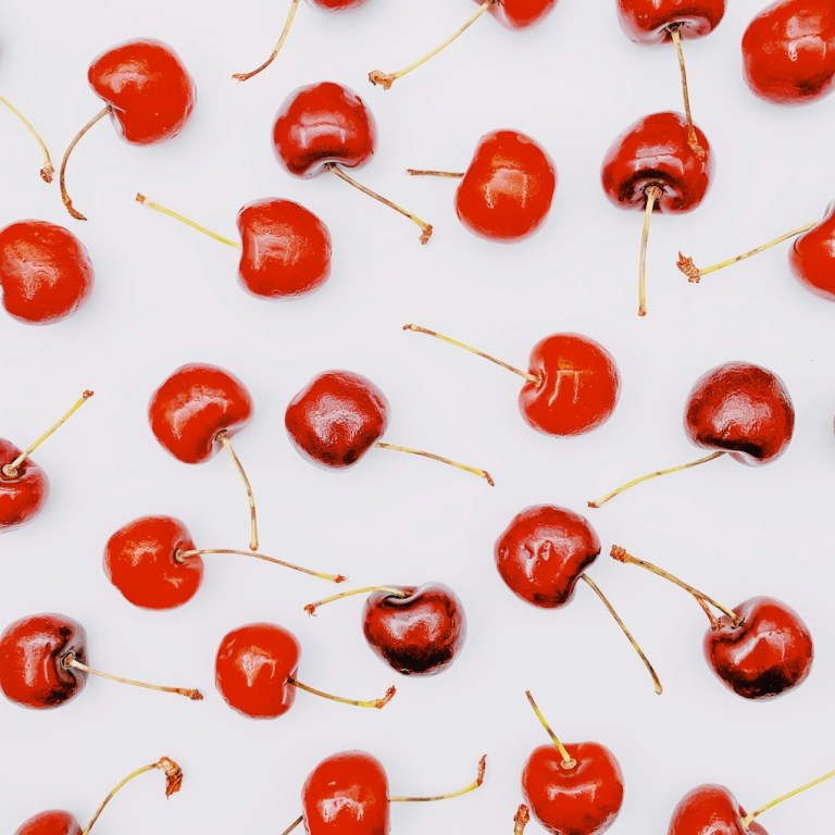 red round fruits on white surface.jpg