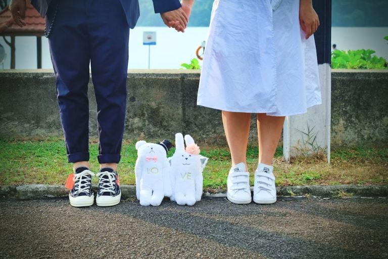 person in white sneakers standing beside person in black pants.jpg