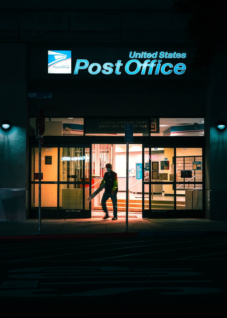 a man entering a post office at night.jpg