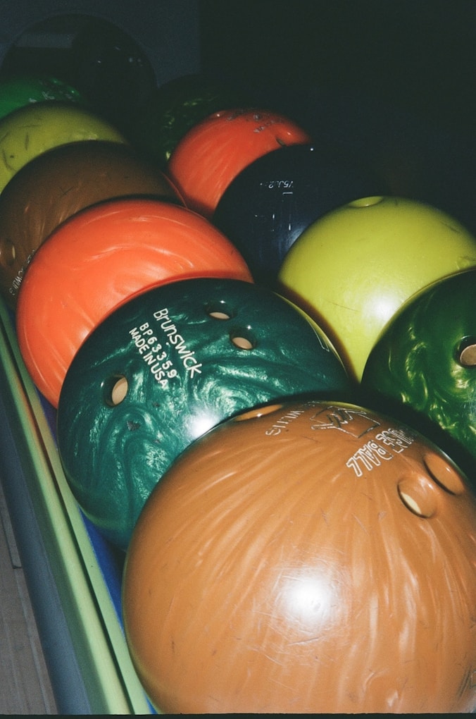 a bunch of bowling balls sitting on top of each other.jpg