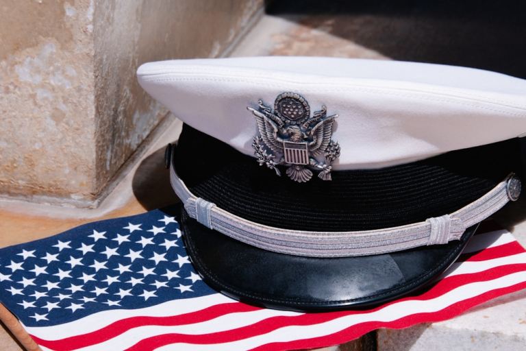 a hat sitting on top of an american flag.jpg
