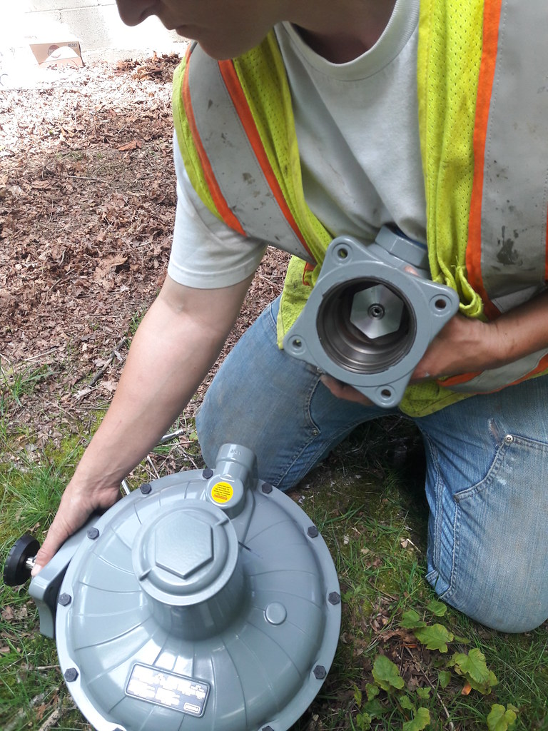 Ryan, pipe fitter, installing the new gas regulator, gas main installation, safety vest, levis, t-shirt, Lakota Lhamo Ling, Dash Point, Washington, USA.jpg