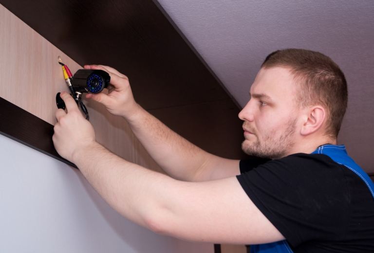 a man working on a wall with a screwdriver.jpg